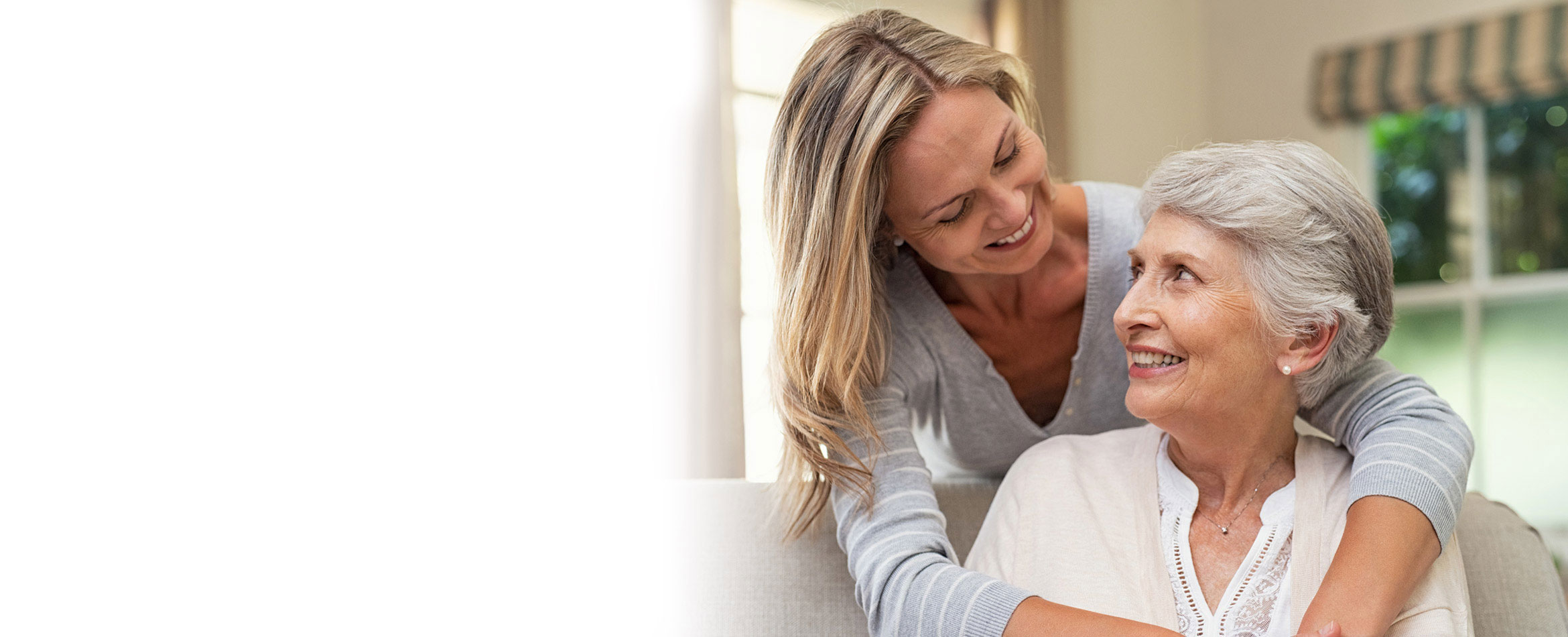 Young and old lady looking at each other